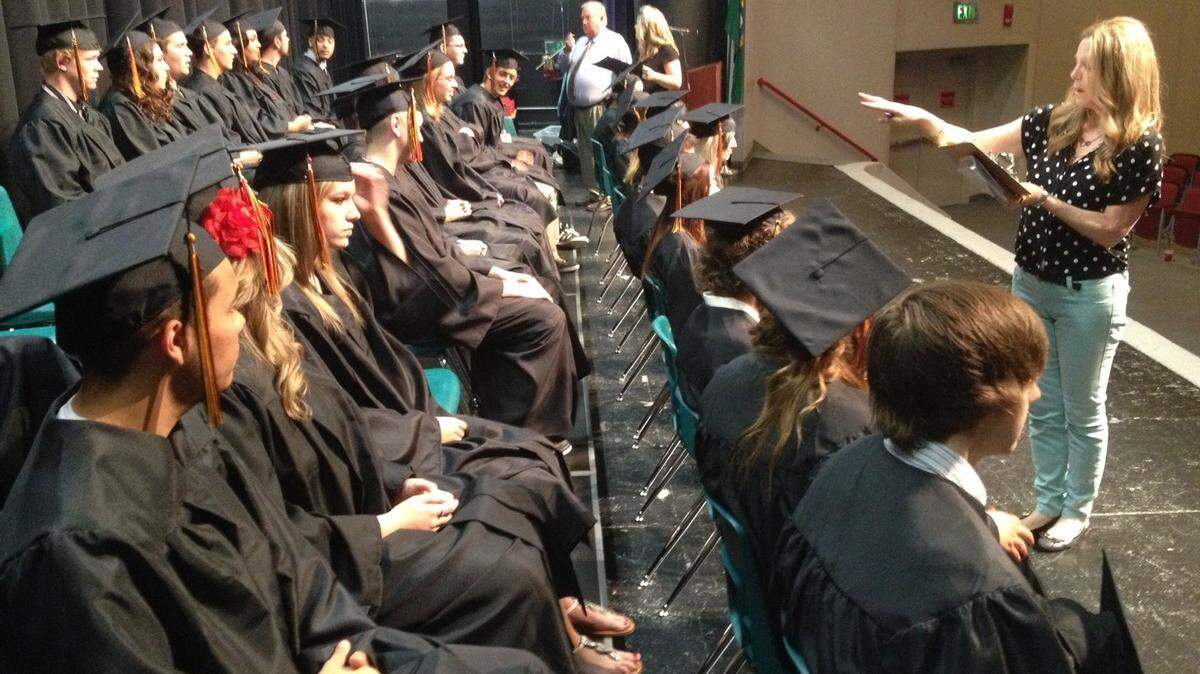 Lead secretary Julie Deen helps organize River's Edge graduates before the start of Friday's ceremony at Chief Joseph Middle School in Richland. The alternative high school in Richland is one of the first of many graduations this weekend around the Mid-Columbia. Here's a link to all the region's graduates.
