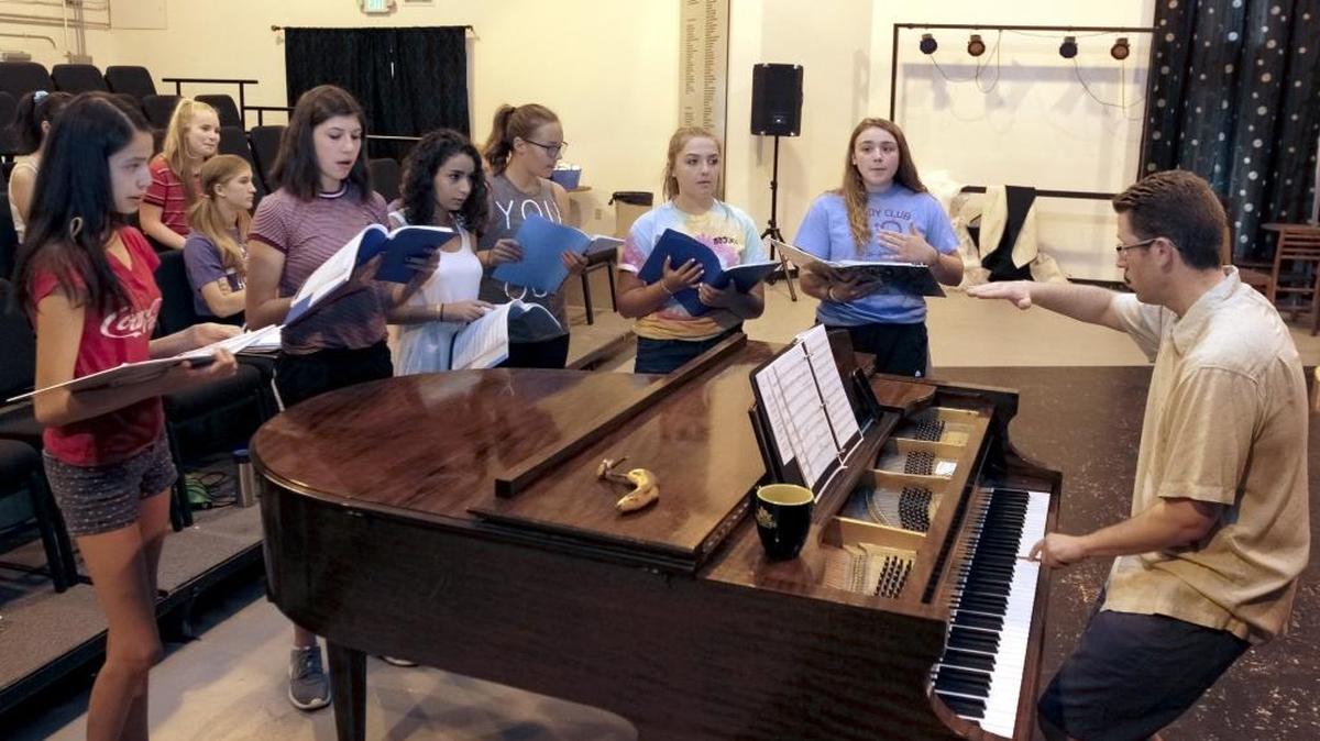 The cast of Beauty and the Beast sing around musical director Justin Raffa as he plays the piano during the ‘Beauty and the Beast’ boot camp at Academy of Children’s Theatre in Richland. ACT is fundraising to add a 300-seat theater to the back of its Richland building on Wellsian Way.