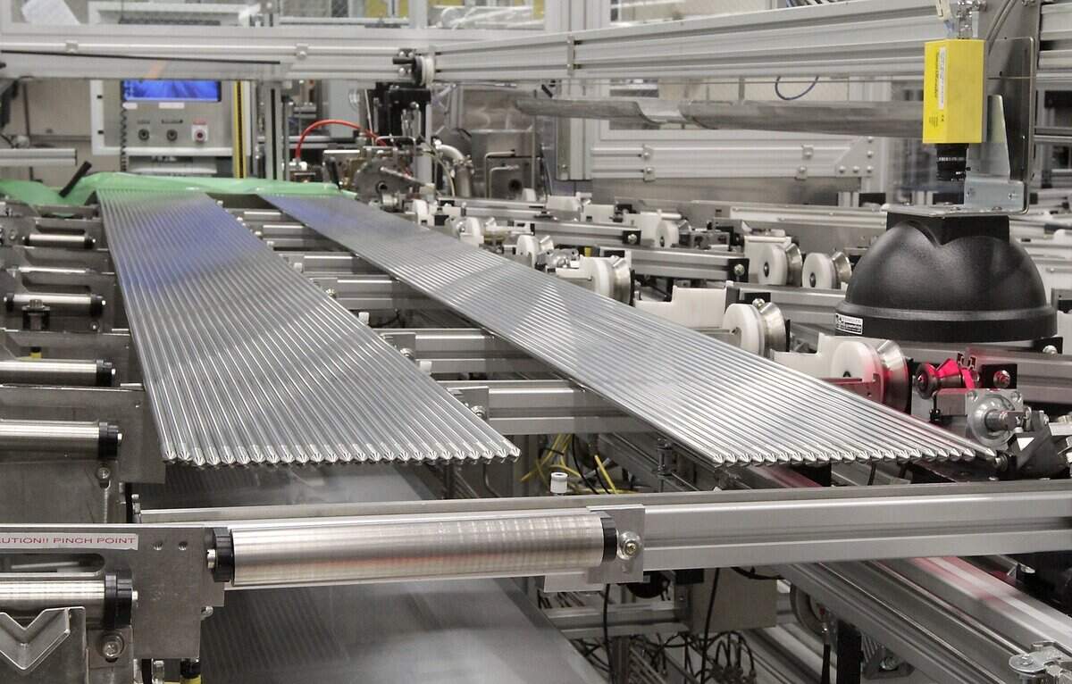Nuclear fuel rods sit on a vibratory rod loading table at the Framatome manufacturing plant in Richland.