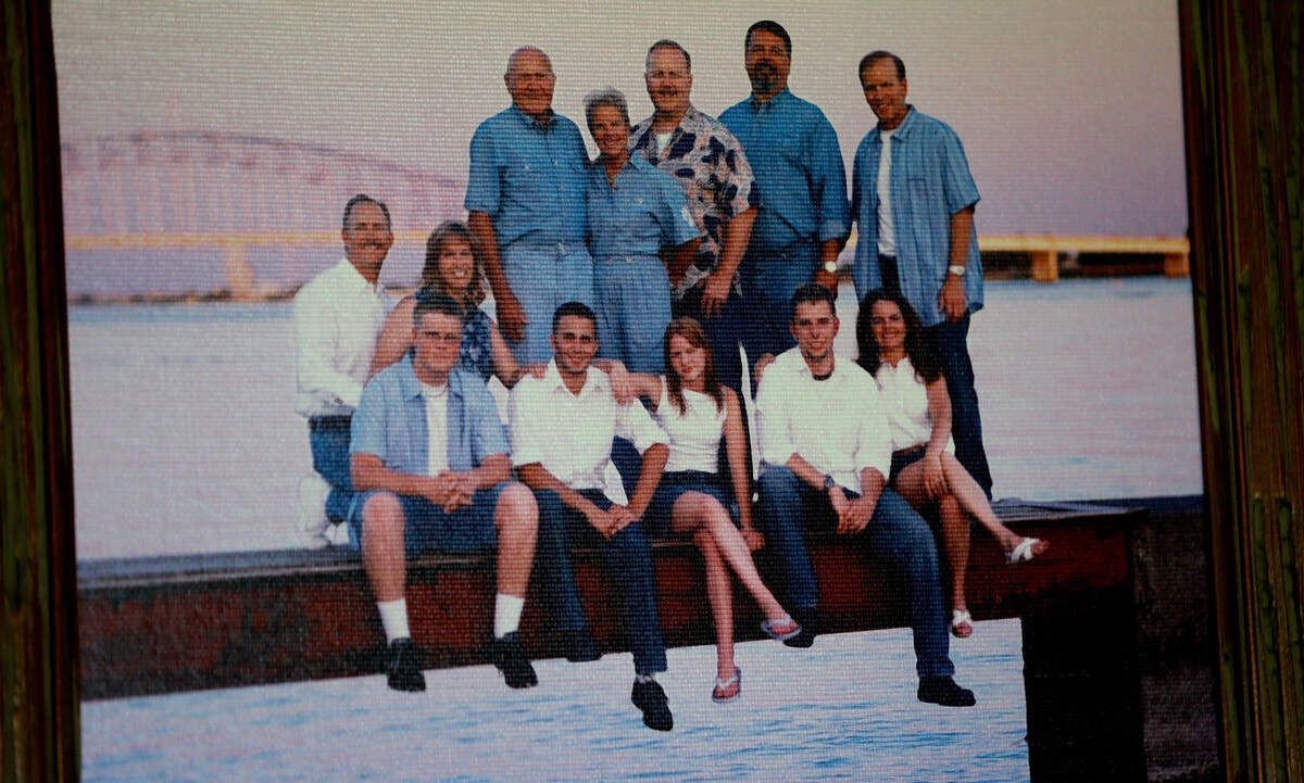 A family portrait from around 2005 shows Lester Schilke surrounded by his family members near the Columbia River with the blue bridge in the background. The retired Tri-Cities dentist will celebrate his 100th birthday on July 11, 2023.