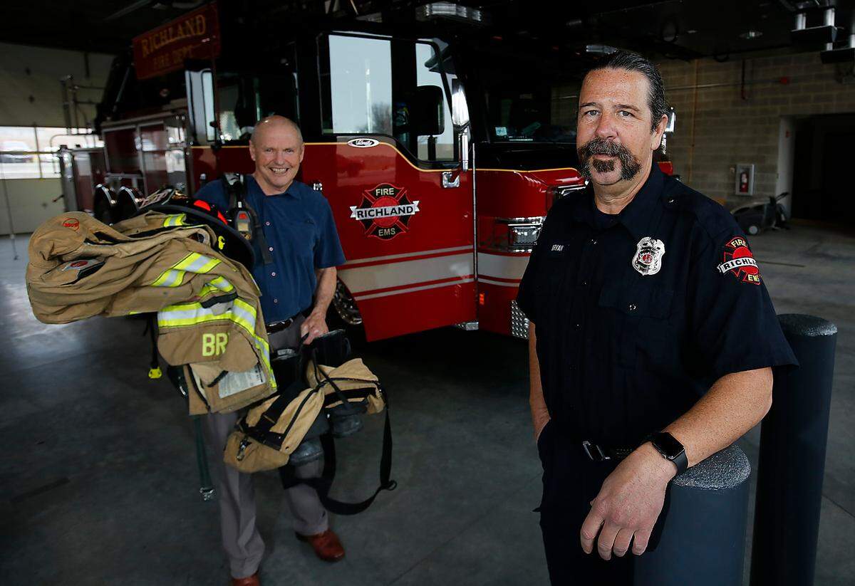 In a reversal of roles from eight years ago, retired Richland fire chief Grant Baynes, left, will follow Richland Fire Capt. Damon Bryan, down the the stairs carrying his heavy protective fire gear after both of them complete Sunday’s stair climb competition in Seattle. Bryan is retiring this year after nearly 28 years of fire service with the Richland Fire Department.