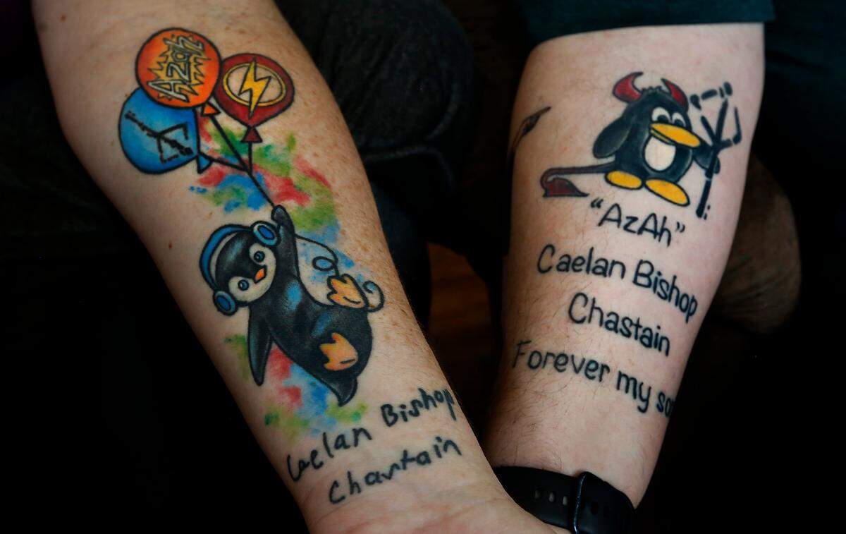 Jim Chastain and his wife, Miriam, show their tattoo tributes to their 17-year-old son, Caelan, who died by suicide in February 2021.