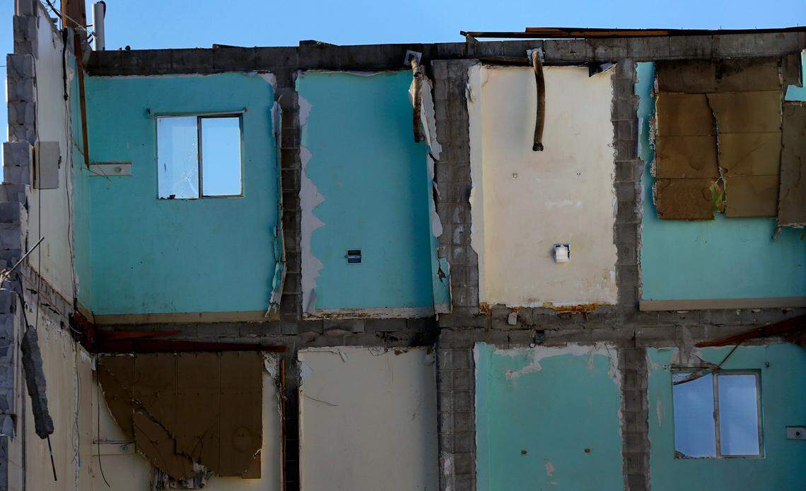 A roll of toilet paper remains in the dispenser of a third floor room as Bart Andrist of Andrist Enterprises of Kennewick uses an excavator to raze the former Thunderbird Motel at 414 W. Columbia St. in Pasco.