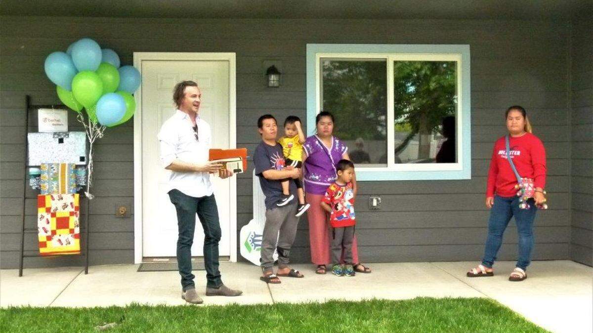 A family of four receives their keys at Habitat for Humanity’s 150th home dedication in Pasco.