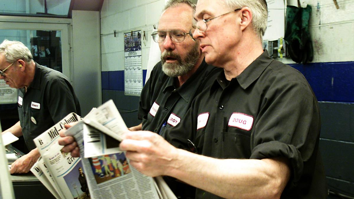 LeRoy Modine checks an edition of the Tri-City Herald in the press room.
