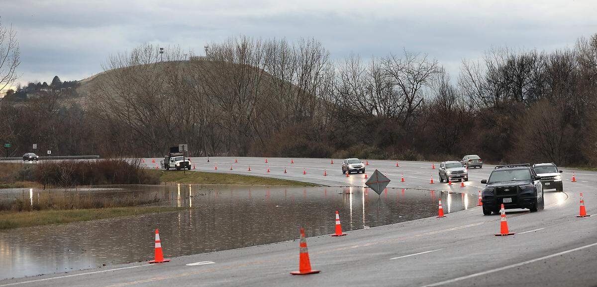 Traffic on Van Giesen Street in Richland is reduced to one-lane each direction Monday morning as floodwaters from the Yakima River recede from their crest over the weekend 