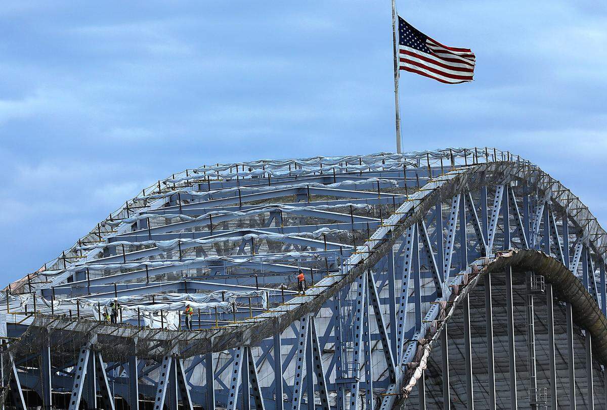Construction workers climbed on the girders last year during the year-log repainting project.
