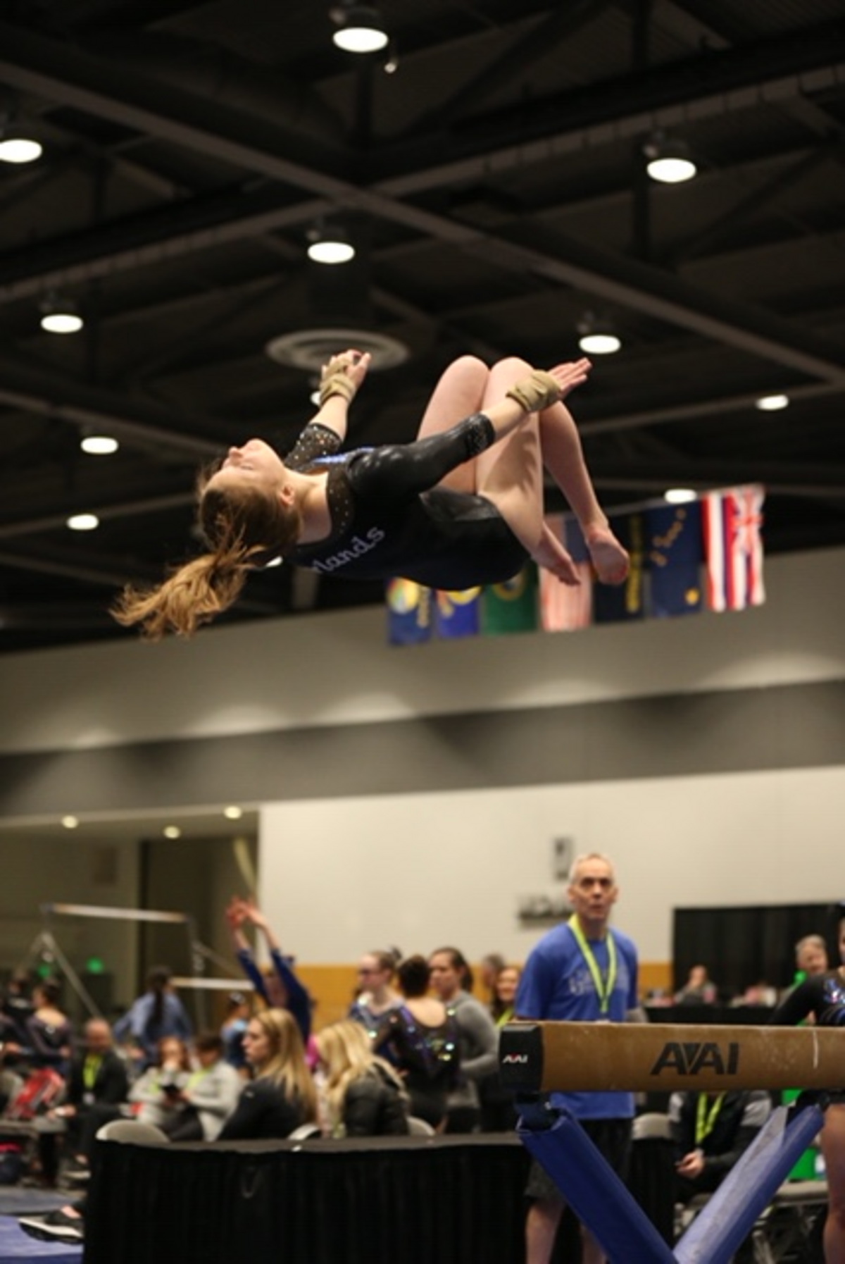 Emily Larson dismounts from the beam.