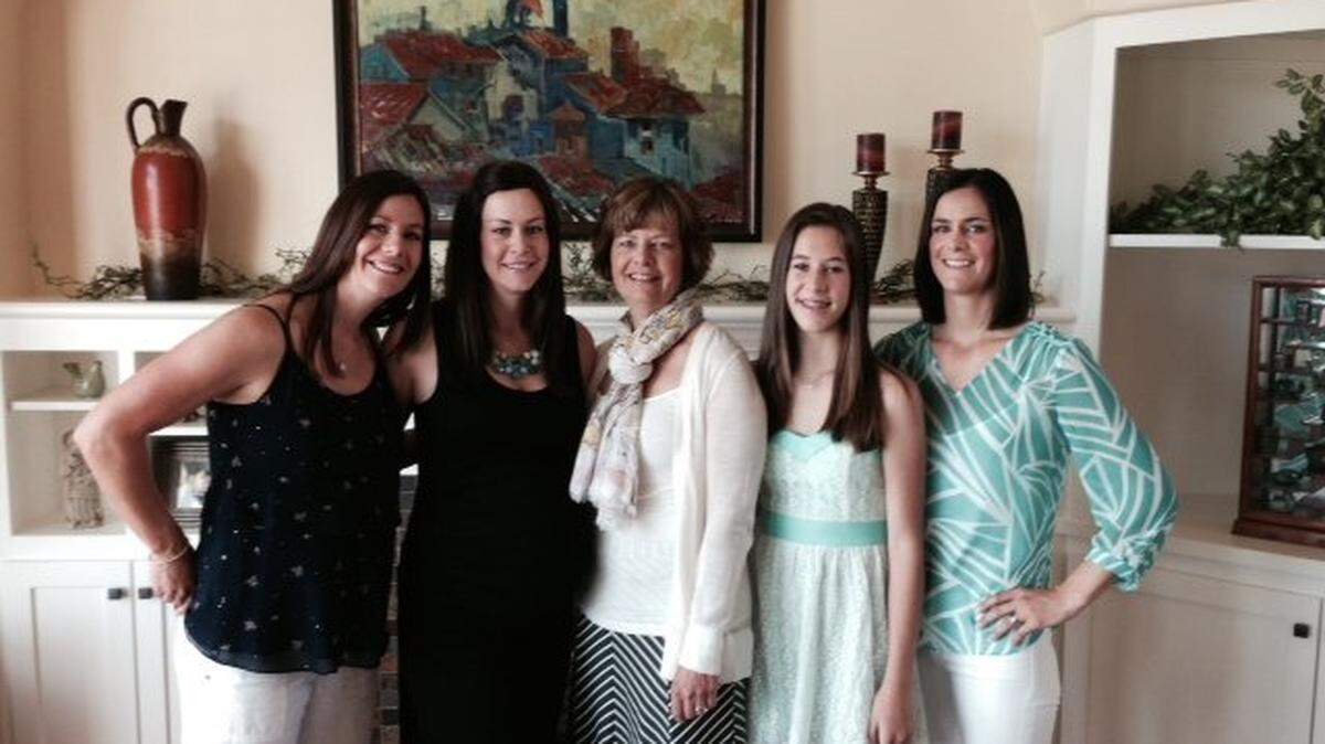 Breast-cancer survivor Kristi Privette poses for a photo with her daughters and granddaughter in her Kennewick home.