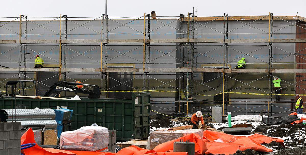 Crews work on the exterior wall from scaffolding preparing to stucco them at the new 5,000-square-foot Chick-fil-A restaurant at 7009 W. Canal Drive in Kennewick. The new building includes a kitchen, inside seating for 70, patio seating for 24, 96 parking stalls and features a two-lane drive through. The existing parking lot has fenced off for construction of the structure. Photo taken on Feb. 18, 2025.
