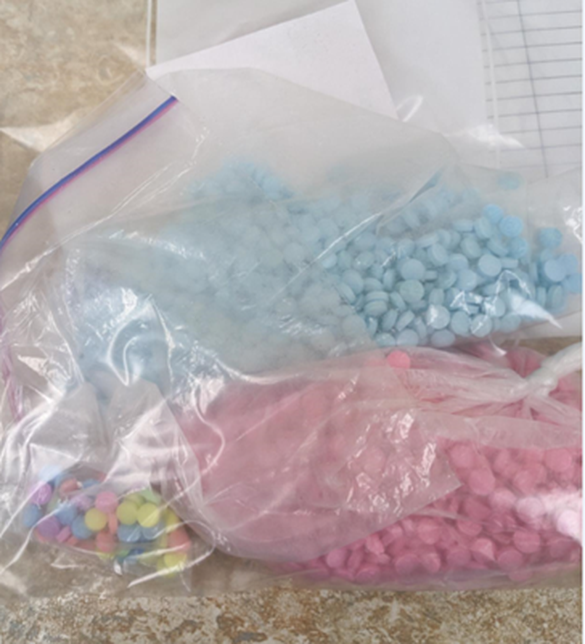 Rainbow, pink and blue fentanyl pills were among about 100,000 seized in December 2022 from a Tri-Cities area drug trafficking operation.