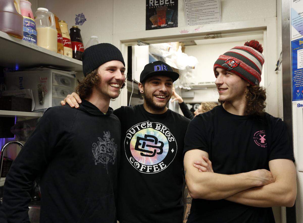 Zade Hakki, center, with co-workers Jake Daniels, left, and Garrit Farrell, right, in 2016.