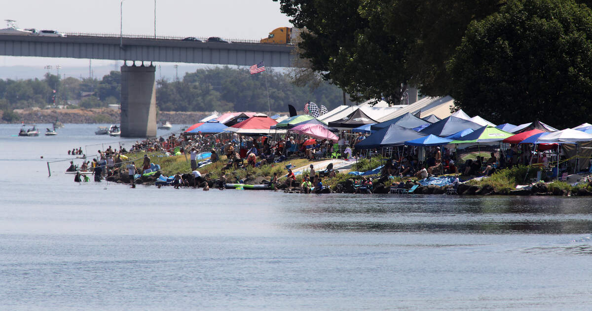 A colorful patchwork of shade canopies cover the Columbia River shoreline upstream of the Neil F. Lampson hydroplane pits for the Columbia Cup hydroplane races and Over The River Air Show in Kennewick’s Columbia Park