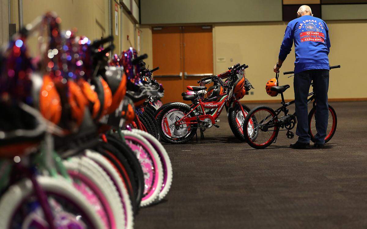 A volunteer lines up finished bicycles during Thursday’s 2024 Bikes for Tikes build day event.
