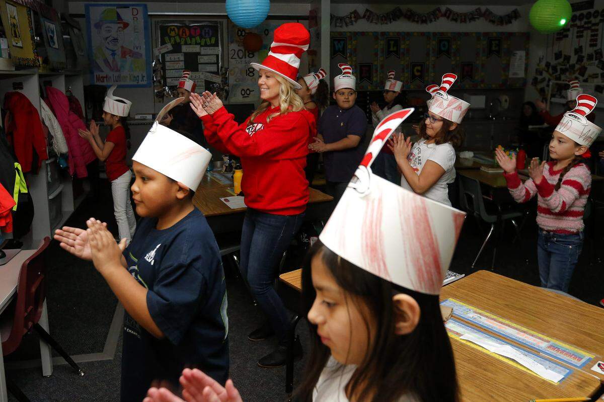 Hawthorne Elementary School’s third-grade teacher Kris Mars dances with her students as a part of their brain break in Feb. 28, 2018 in Kennewick. After her students have been working hard in class they are rewarded with a break called brain break.