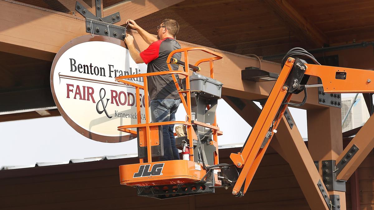 Fair board member Brian Goulet installs signs around the Benton County Fairgrounds in preparation for next week’s 70th annual Benton Franklin Fair & Rodeo in Kennewick. The fair parade starts at 10 a.m. Saturday in downtown Kennewick. The opening day of the fair is Aug. 21.