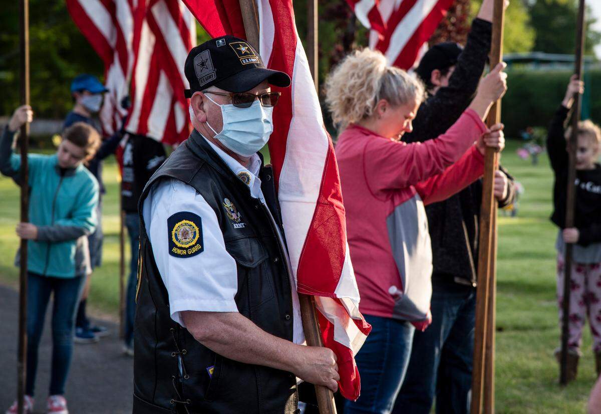 James Taylor, 60, of Kennewick, waits to place a flag along the Avenue of Flags honoring fallen soldiers at Sunset Gardens in Richland on Memorial Day. Taylor served in the Army’s Military Police for 10 years.
