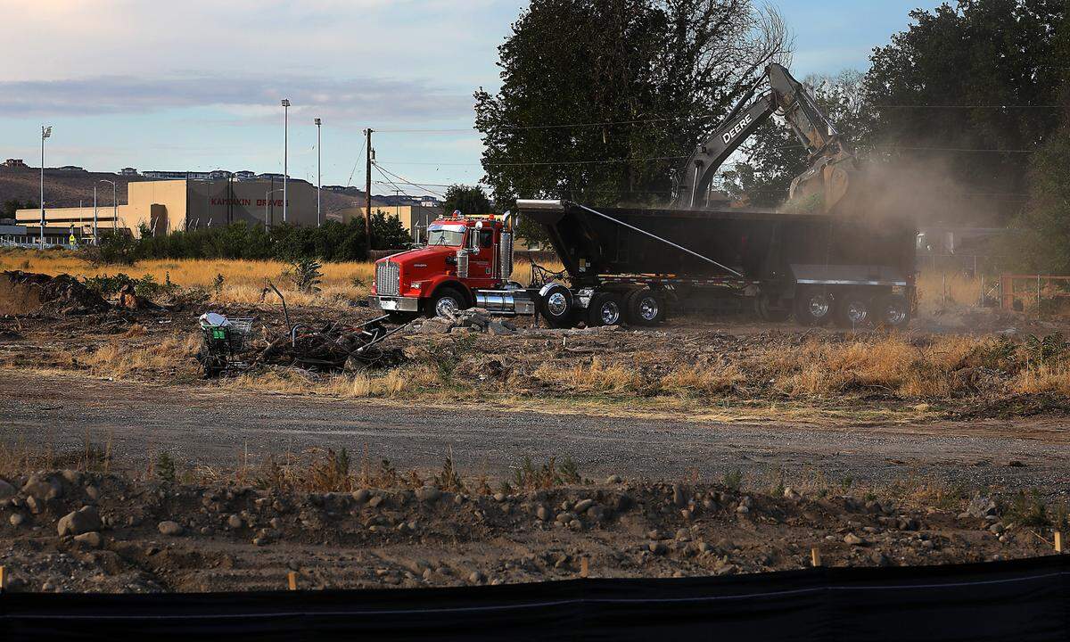 Heavy equipment clears lots in the 4700 block of West Canal Drive in preparation for Canal Landing, a 101-unit townhome project in Kennewick.