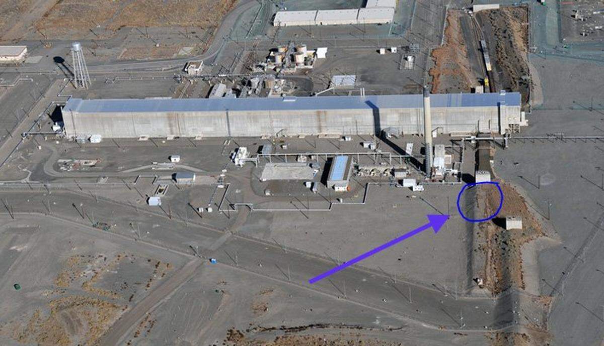 This aerial photo shows the waste disposal tunnel near the PUREX plant before it collapsed at the Hanford nuclear reservation. The blue circle indicates the location of the breach, which has since been filled.