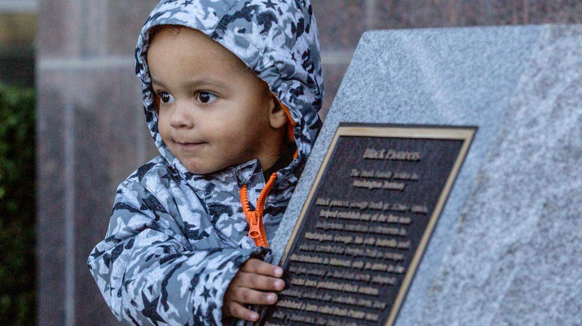 Avery Fite, 2, stands next to a new monument on WSU Tri-Cities campus commemorating George Bush, the first Black pioneer in Washington Territory, and his son William Owen Bush, who served in the first Washington state legislature after a dedication ceremony celebrating Black History Month.