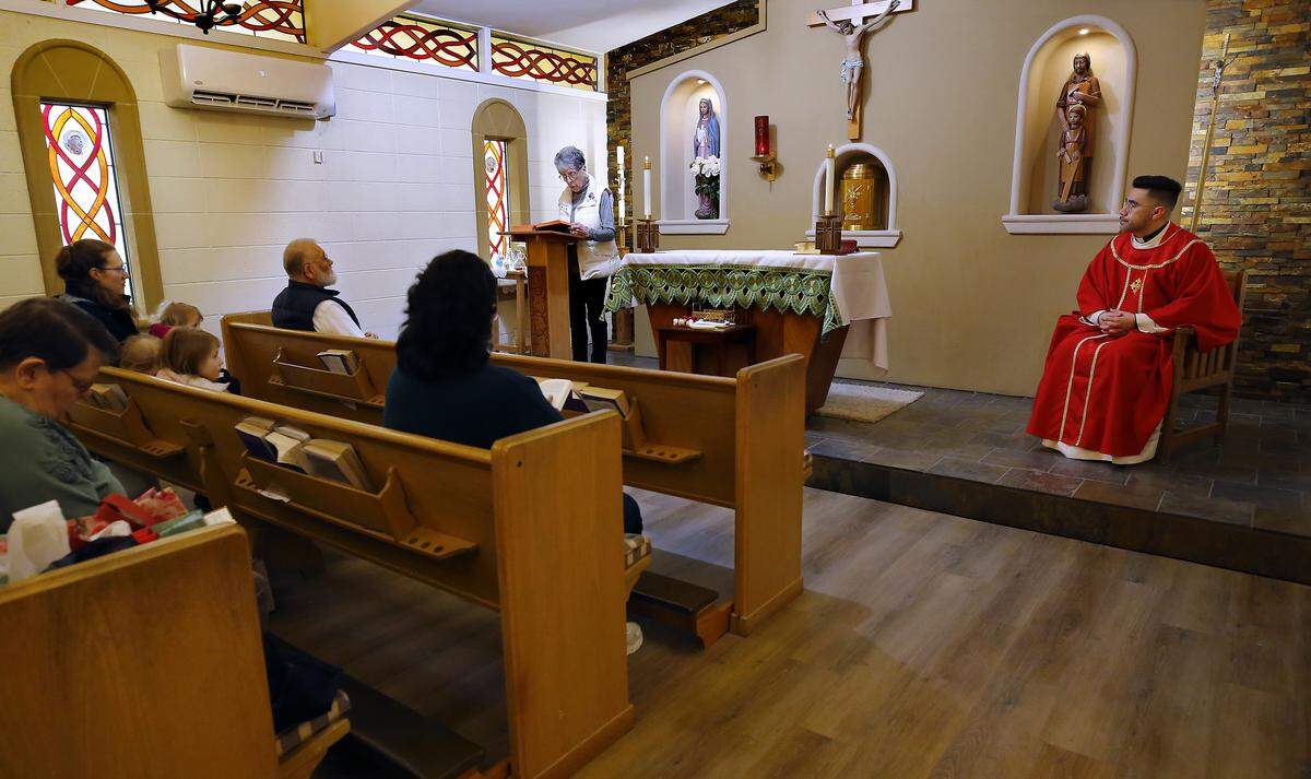 Parishioner Mary Jo Butterly,  left,  helps Rev. Cesar Izquierdo conduct a recent morning mass held in the chapel of the St. Rose of Lima Catholic Church in Ephrata.
