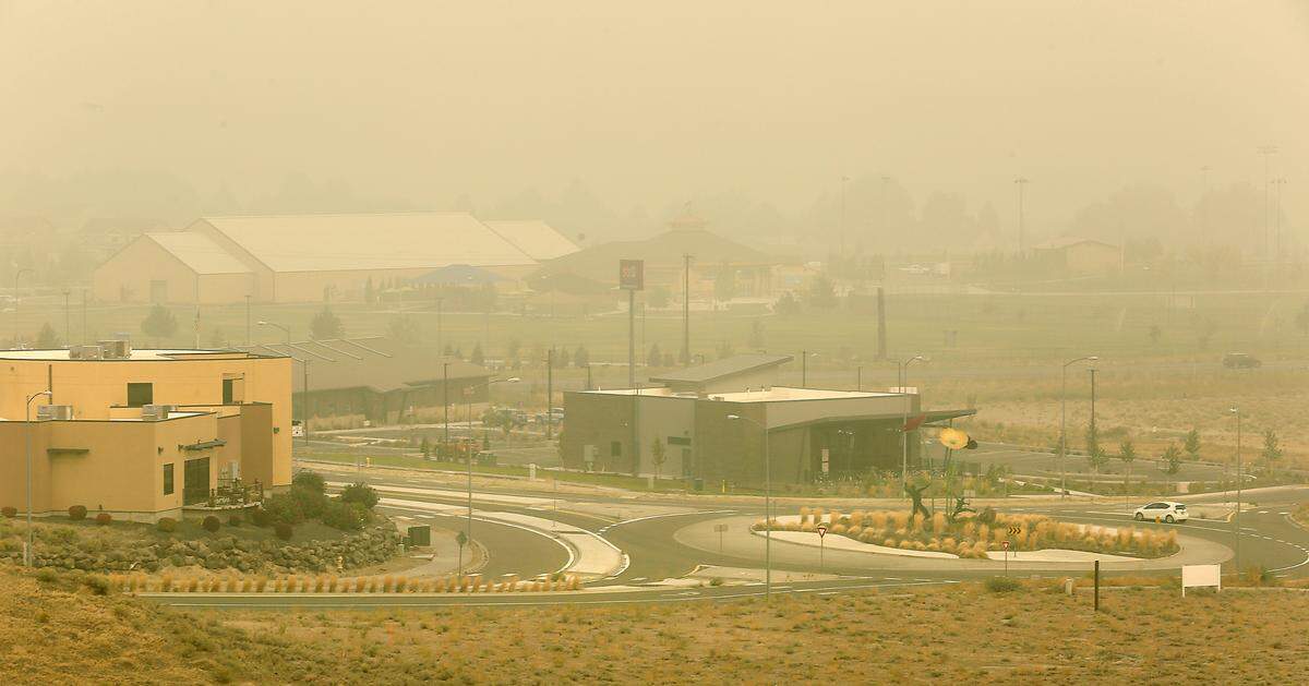 A motorist navigates the roundabout on Hildebrand Boulevard near Zintel Way in September 2020 when the air was so smoky that air quality was rated as “hazardous,” the worst in a decade.