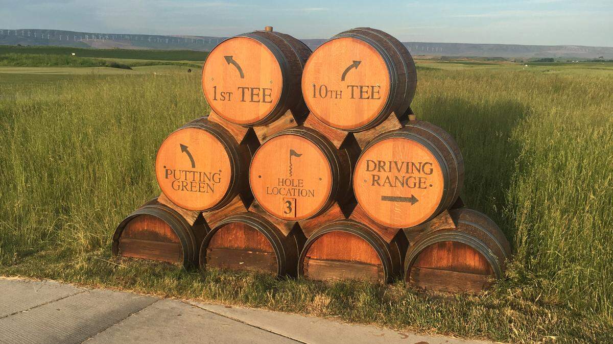 A series of barrels at Wine Valley Golf Course tells golfers where the 1st tee, 10th tee, putting green and driving range are located.