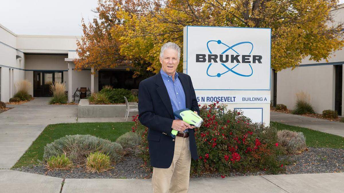 John Landefeld, co-founder and general manager of Bruker’s Kennewick-based portable X-ray flourescence devices business, holds the company’s Titan model. The Kennewick plant is closing.