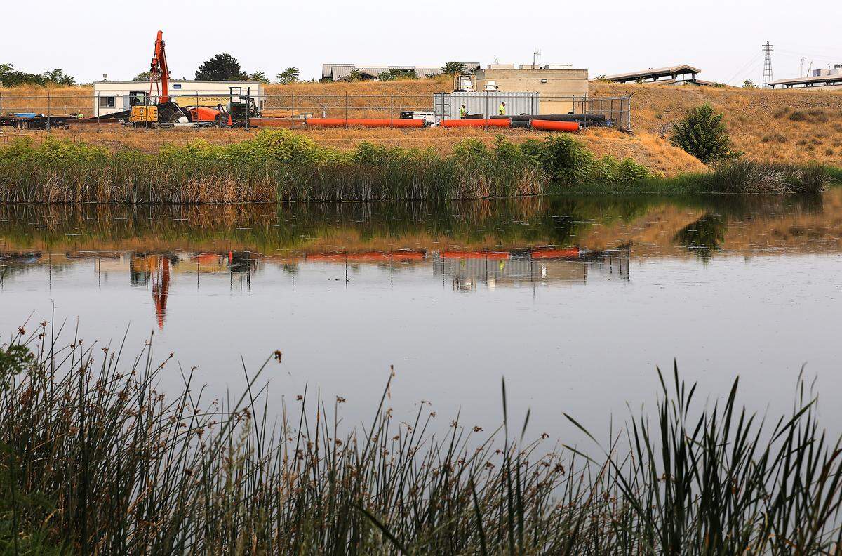 Equipment and construction supplies staged adjacent to Duffy's Pond near Clover Island in Kennewick.
