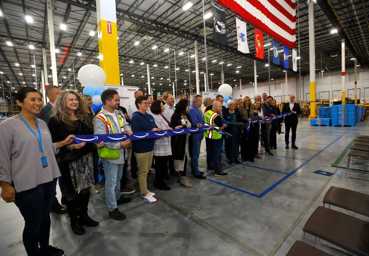 Amazon employees and local dignitaries hold a ribbon cutting ceremony for Amazon’s inbound cross dock facility in Pasco that is expected to employ more than 1,500 associates.