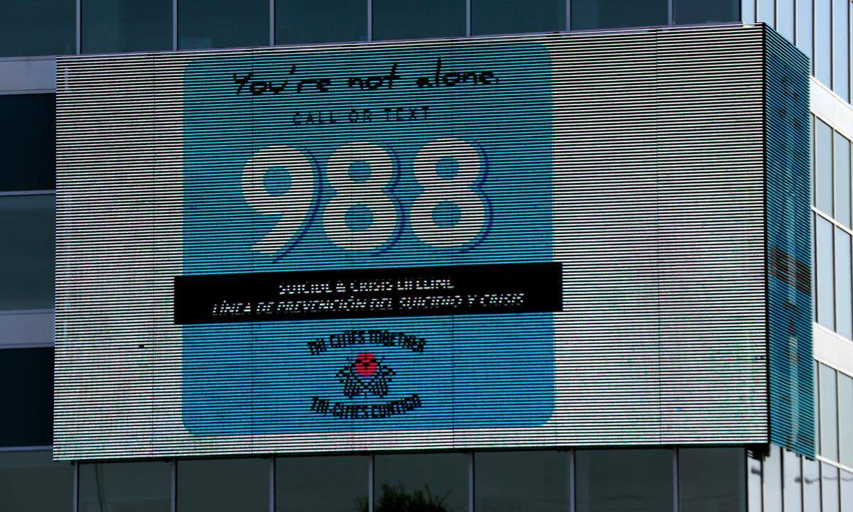 The electronic message board on the HAPO building on the corner of West Clearwater Avenue and Columbia Center Boulevard in Kennewick displays a message for the Tri-Cities Together suicide and crisis lifeline telephone and text number: 988.