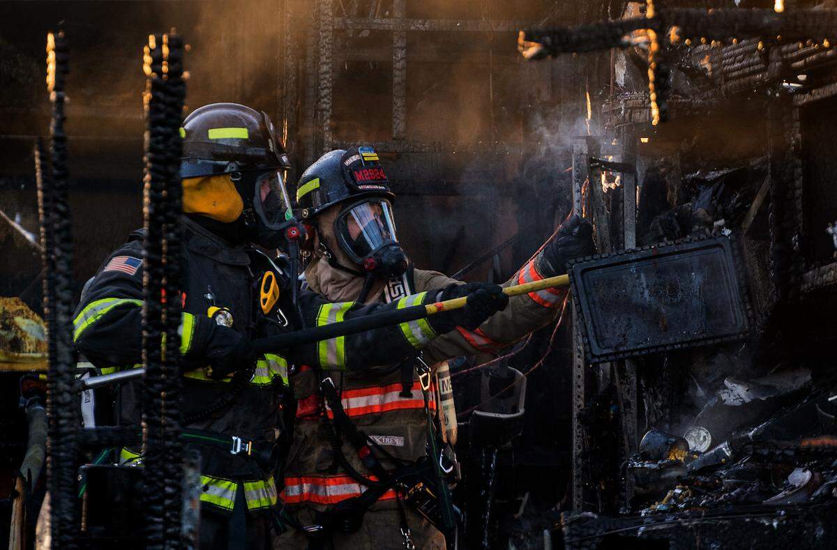 Firefighters work outside a heavily damaged trailer at the Green Tree RV Park and Mini Storage at 2103 N. 5th Ave. in Pasco. Fire officials say two adults and a child lost their home after the blaze started in the living area and consumed the trailer.&nbsp;No one was hurt but a pet cat died, said Ben Shearer with the Pasco Fire Department.&nbsp;The Red Cross was called to assist the family.