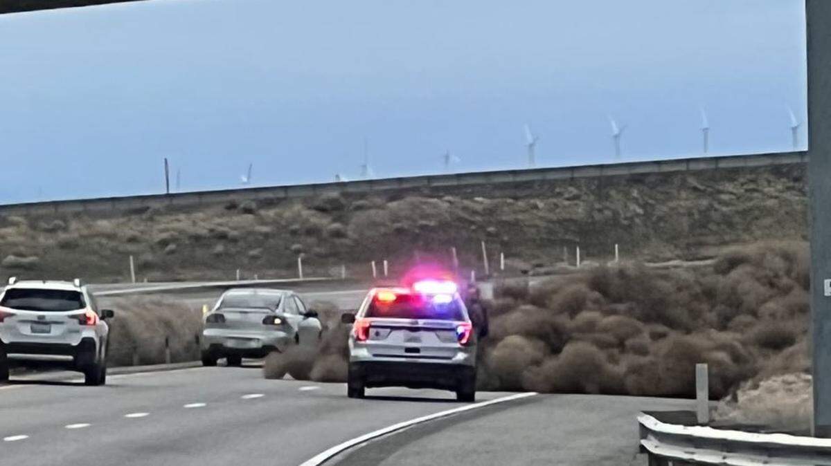 High winds pushed a wall of tumbleweeds across Interstate 82, blocking one lane near the Highway 395 exit into Kennewick.