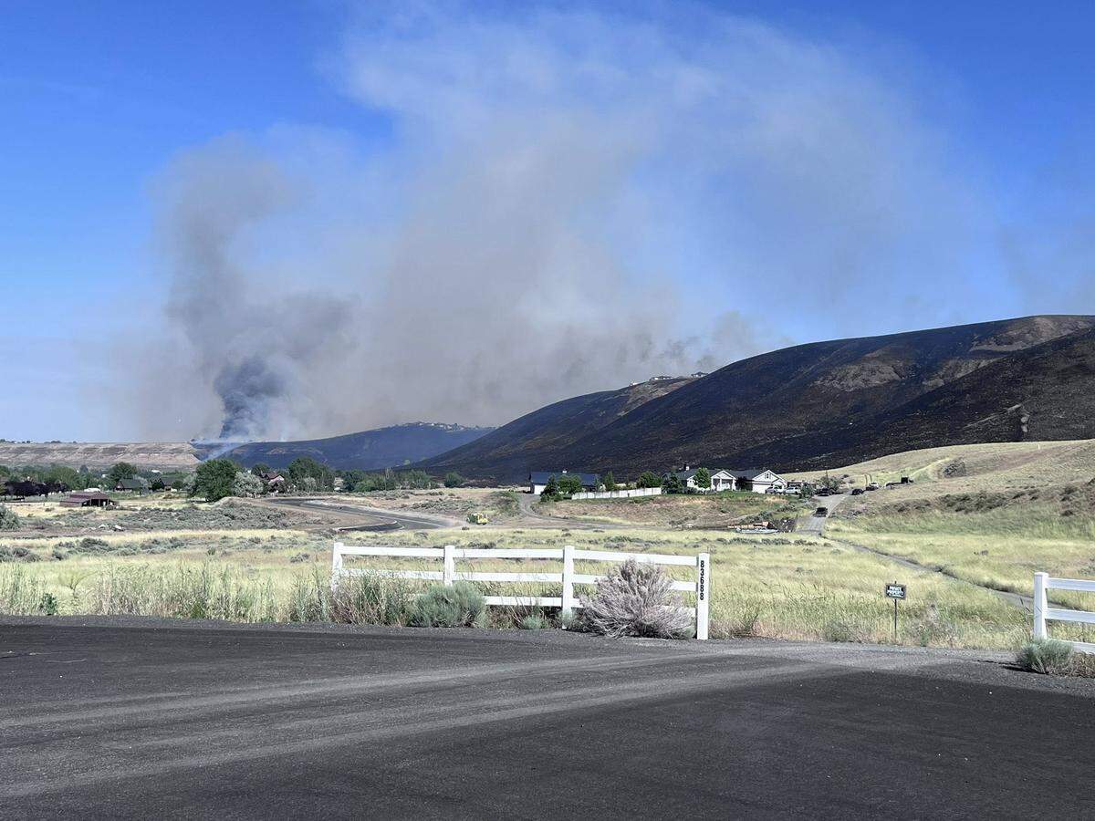 The Country Meadows Fire spread quickly uphill in dry and breezy conditions on Saturday.