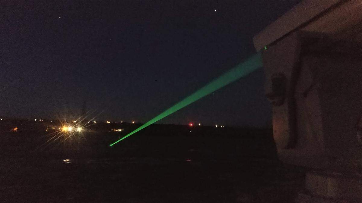 This laser at McNary Dam emits a bright green light that birds perceive as a solid object, which causes them to fly out of the way.