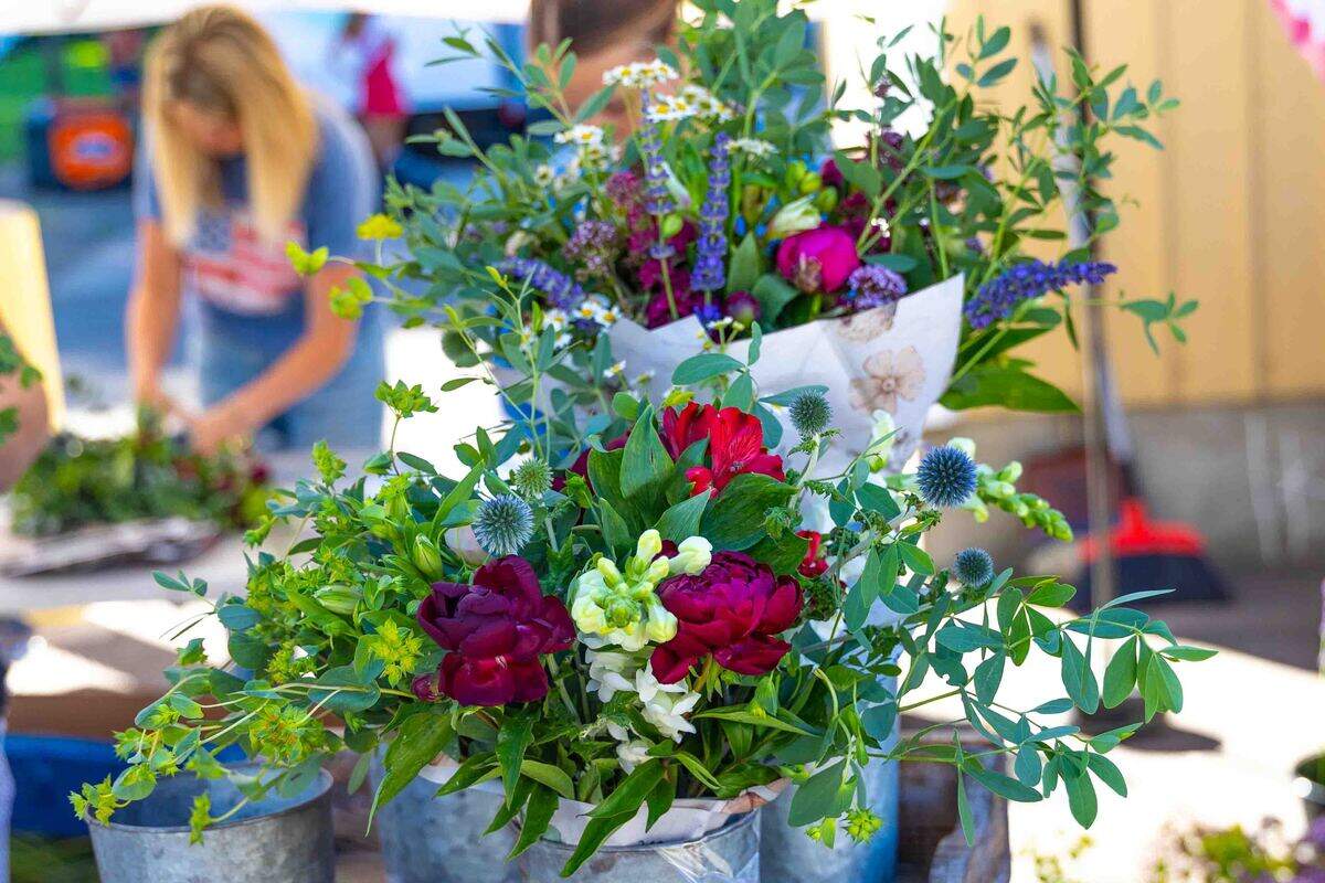 Fresh-cut flower bouquets are displayed for sale Saturday at the Prosser Farmers Market during Prosser’s Old-Fashioned Fourth of July celebration. Local vendors offered seasonal flowers, produce and handmade goods as shoppers visited the holiday market in Prosser City Park.