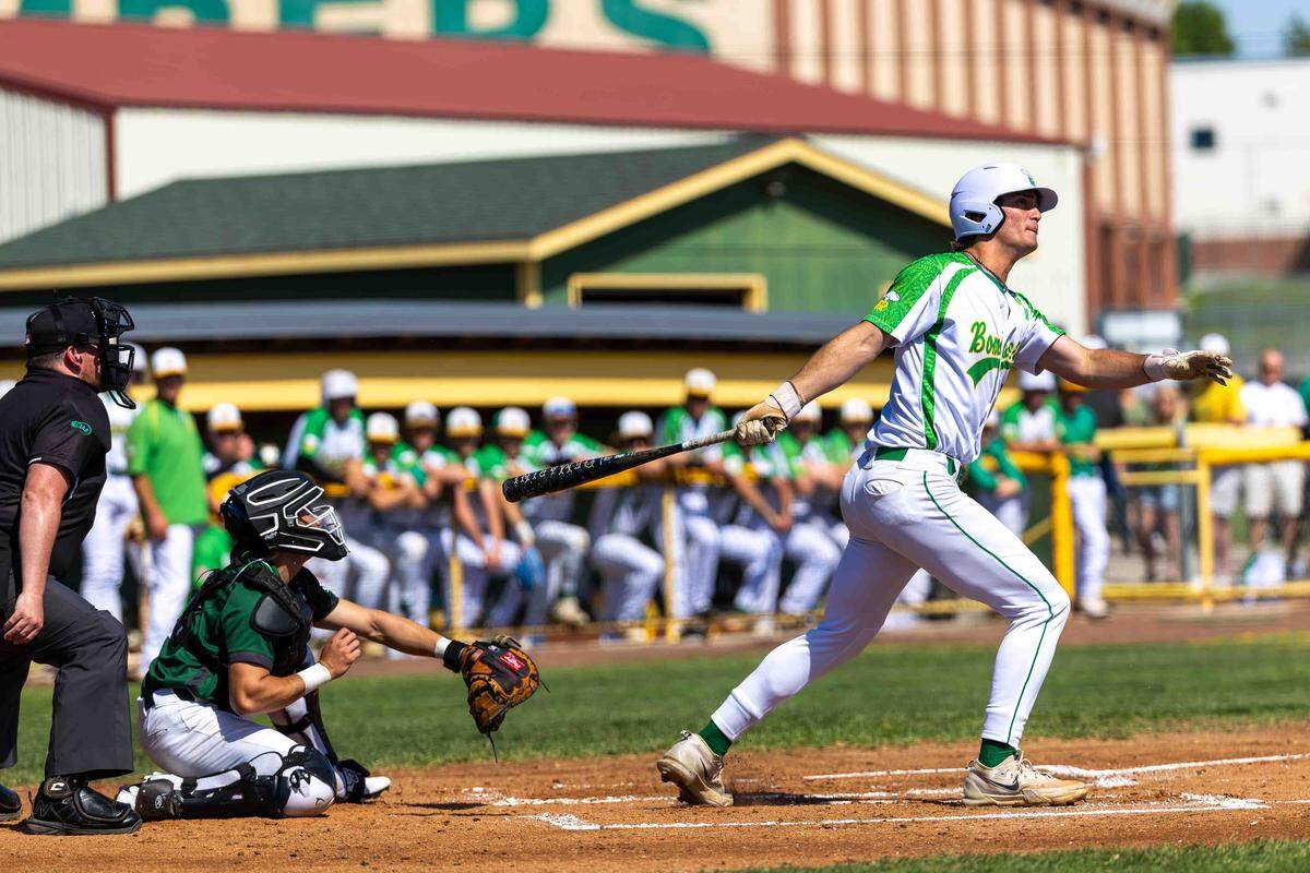 Richland senior pitcher Michael Revell follows through after driving a hit into the outfield against the Skyline Spartans during opening-round play at the WIAA 4A State Baseball Championships Saturday at Bomber Bowl in Richland.