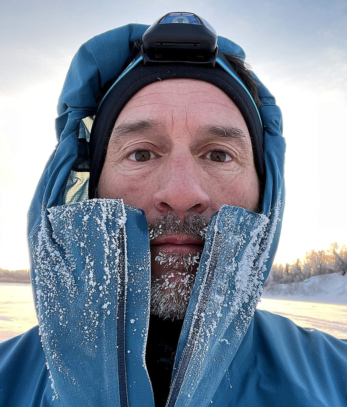 Ice and frost buildup on the coat and face of Brandon Lott during his recent running of the Iditarod Trail Invitational event in Alaska.
