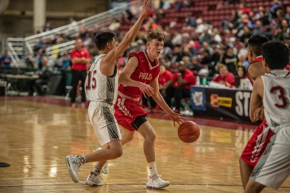 Kaden Swift of Prosser brings the ball around Riley Mesplie of Toppenish.