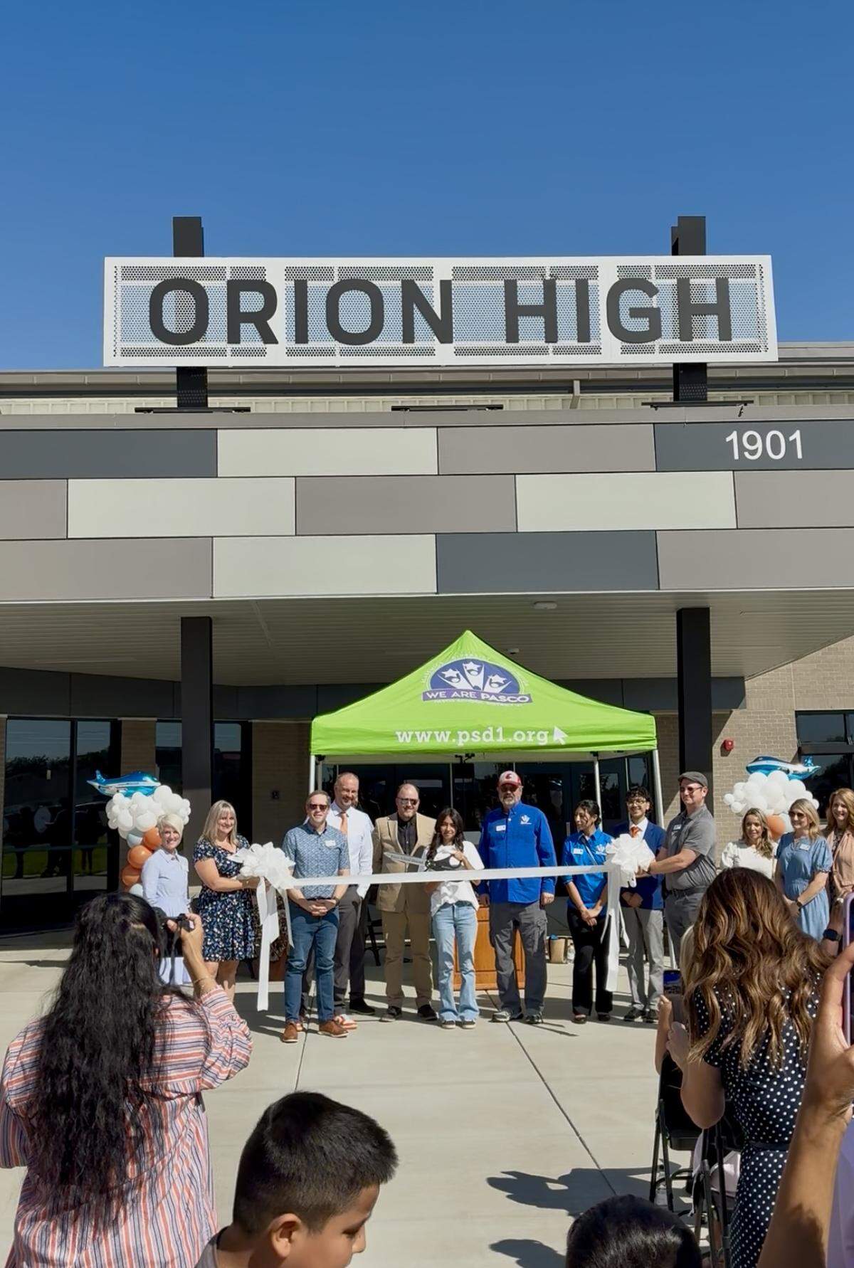 District leaders and students prepare to cut the ribbon at Orion High School’s grand opening in Pasco, marking the official launch of the new Career & College Academy.