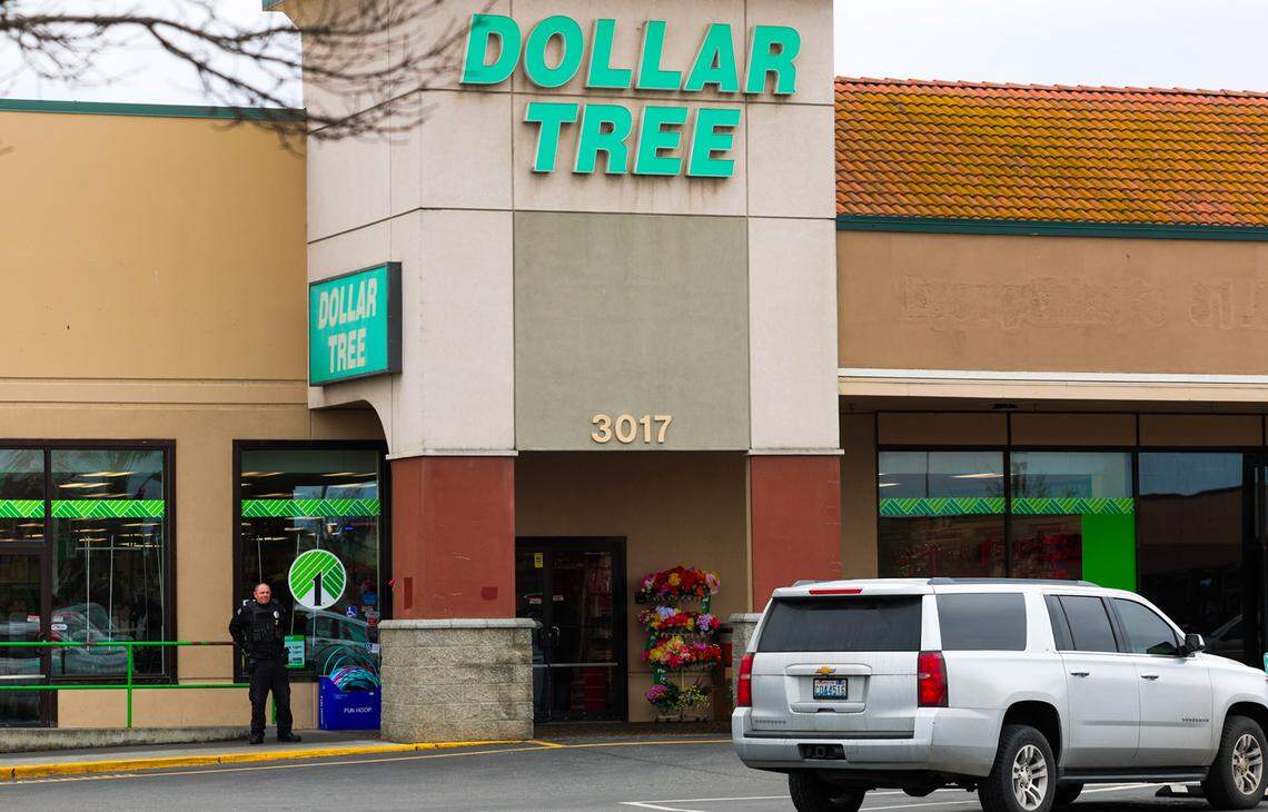 A security guard stands outside the Dollar Tree store after the fatal stabbing in the parking lot in February 2026.