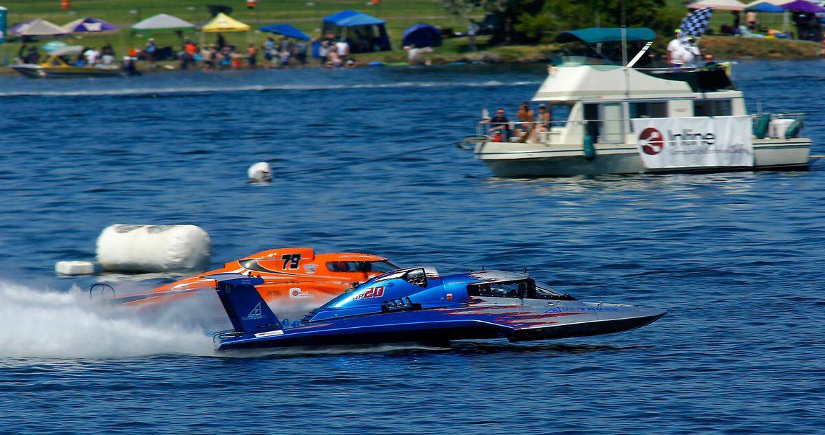 Jeff Bernard in the GP-79 edges out Ed Preston in the GP-20 at the finish line marker buoy of their first heat race Saturday during Columbia Cup racing action in the Tri-Cities