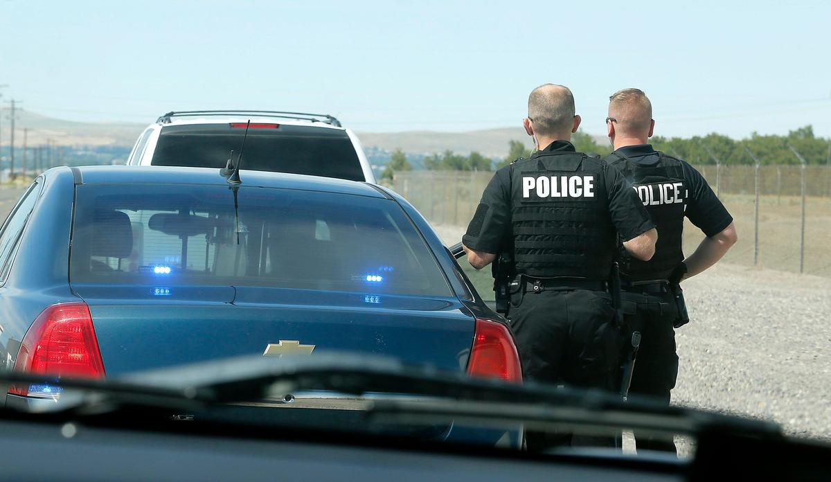 Members of the Kennewick Police Department’s Criminal Apprehension Team prepare to take Travis Lee Harden into custody following a traffic stop on Sacajawea Park Road off Highway 12 near Pasco.