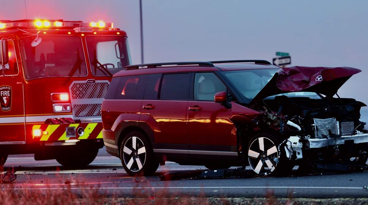 Washington State Patrol troopers investigate a two-vehicle crash near Highway 395 and East Vineyard Road early Tuesday.