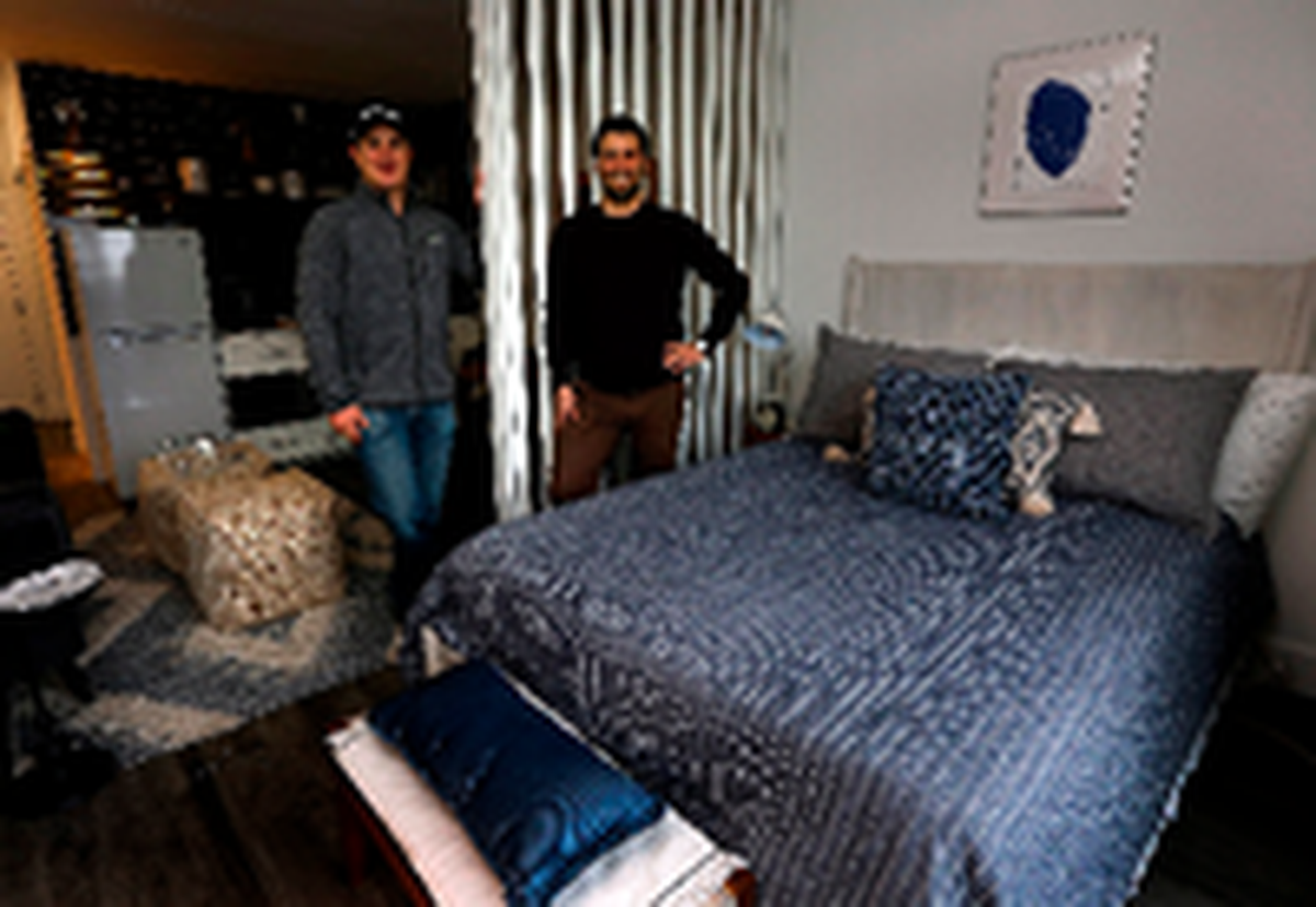 Fortify Holdings co-regional managers Rob Jacobs, left, and his brother, Daniel, stand in 2023 in a finished model micro apartment inside The Franklin complex in Richland. The company was transforming the former Best Western Plus on George Washington Way into about 200 apartments.