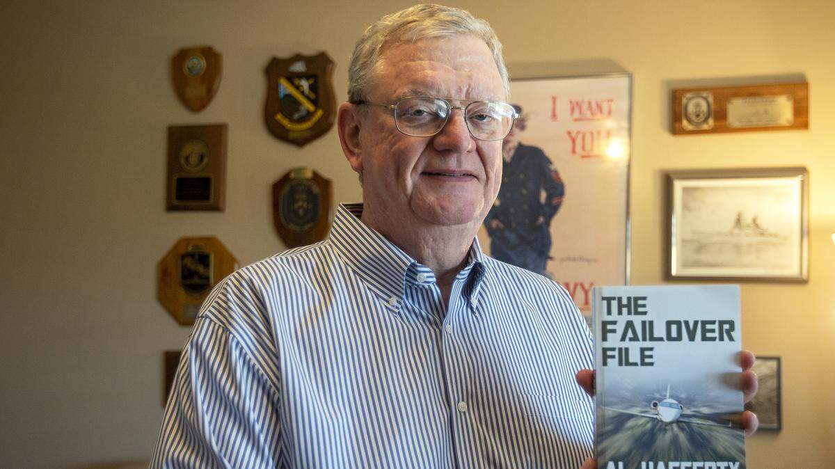 Al Haggerty holds his new mystery thriller, “The Failover File.” Even though he spent decades in the worlds of military and defense, he always wanted to write books.