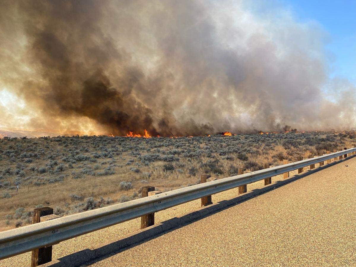 A wildfire burning west of Ontario, Ore., closed Interstate 84 eastbound from Pendleton to Ontario on Thursday.