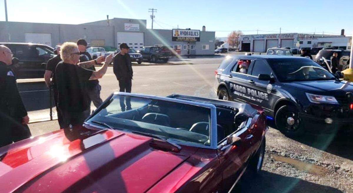 Food Network star Guy Fieri snaps a photo of one of his production crew members in a bunny suit in the back of a Pasco police car this week while they were in town filming for Diners, Drive-Ins and Dives. Members of Fieri’s production crew who screw-up something have to wear the bunny suit for a day.