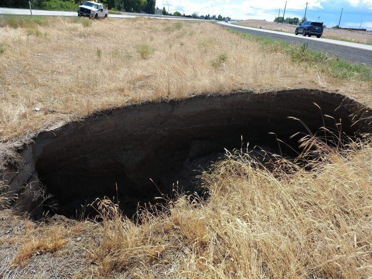 A sinkhole measuring about 15 feet deep and 30 feet wide closed I-82 eastbound lanes west of Prosser at milepost 54 near Zillah. WASHINGTON STATE DEPARTMENT OF TRANSPORTATION.