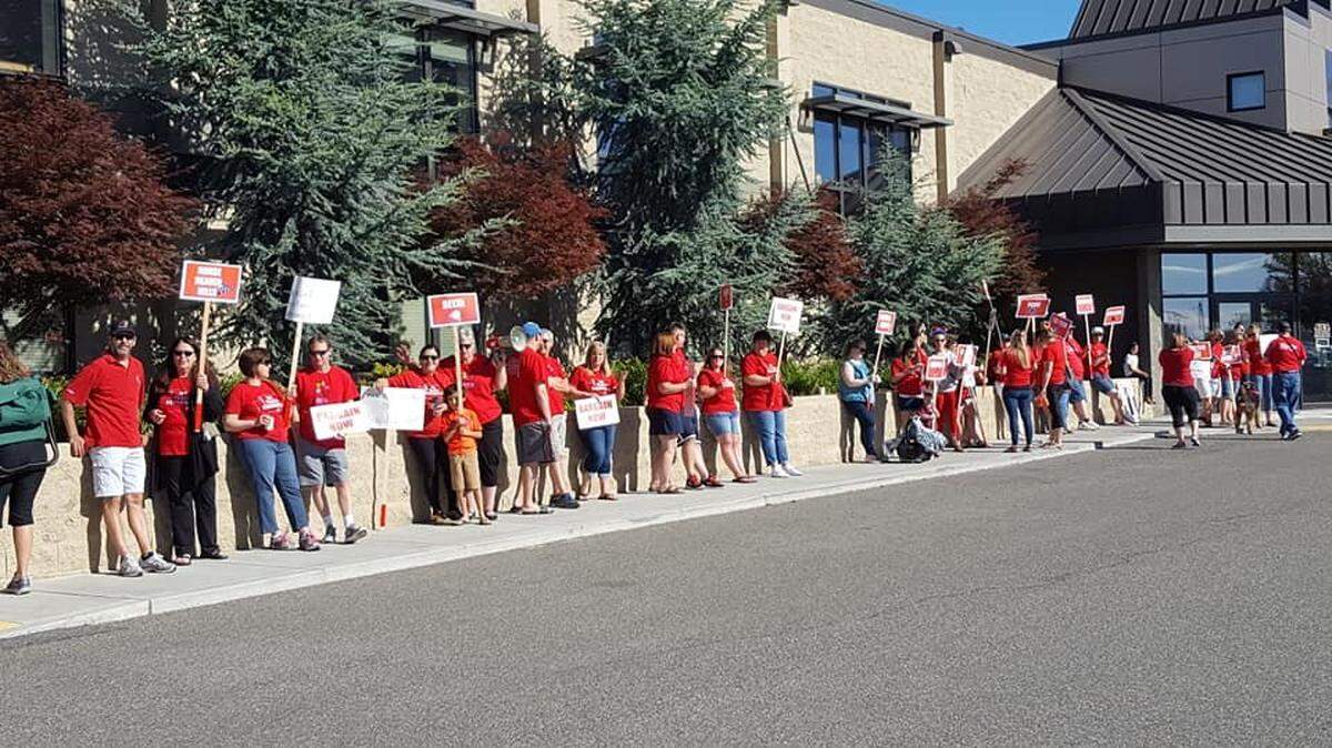 Kennewick teachers rally at the school district office this summer.